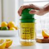 Sur La Table Manual Citrus Juicer – High-Performance Hand Juicer with Clear Measuring Cup, Yellow Reaming Cone, Green Plunger & Metal Prong for Maximum Juice Extraction